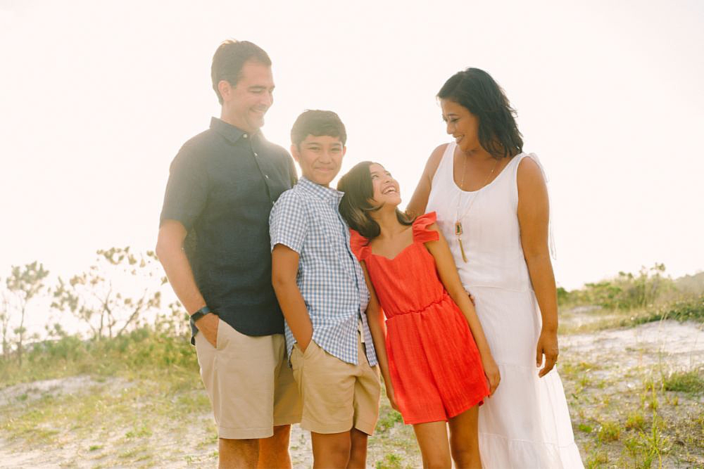 photo of family standing in front of the dunes during beach photo session in 30A