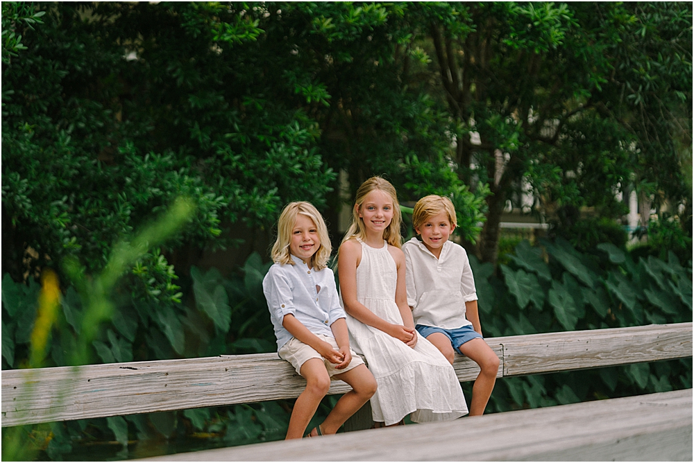 kids sitting on a fence in 30A